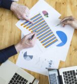 Budget vs actual analysis meeting for a nonprofit organization reviewing financial reports and budget variance data